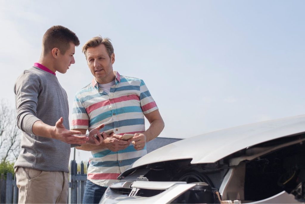 Padre y conductor novel revisando opciones de seguro de coche y coberturas